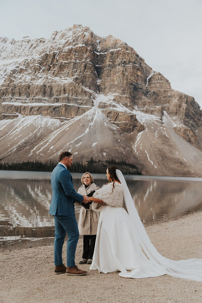 an eloping couple during their ceremony in Banff Alberta