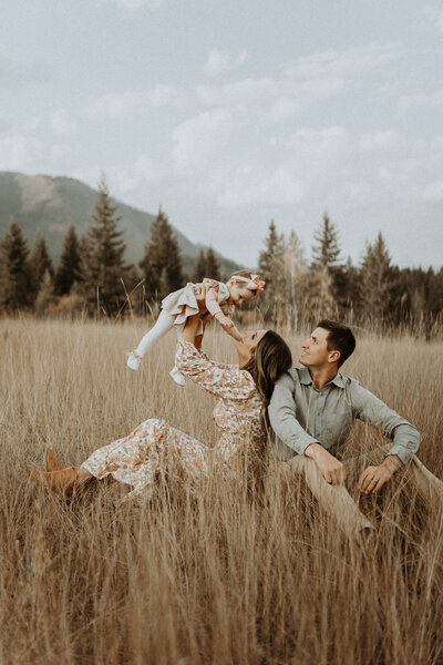photo of family playing in an open field in montana