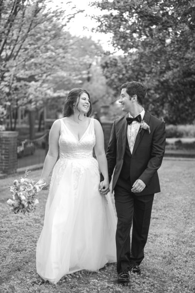 bride and groom looking out a window of the DAR while holding each other close