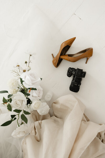 Behind-the-scenes branding image of Abby Dutra, a Kentucky and Cincinnati wedding photographer, setting up a studio shot.