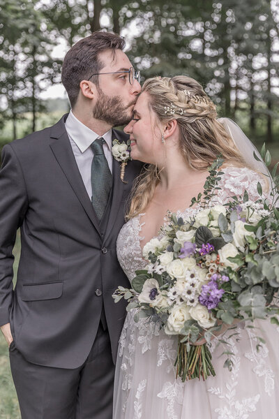 Groom giving the bride a kiss