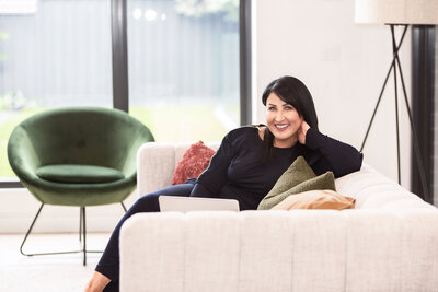 Business woman relaxing in an arm chair reading