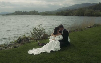 Married couple enjoying a serene moment together by the lake, reflecting their love and connection amidst a breathtaking natural setting