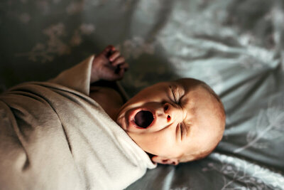Newborn baby boy yawning.