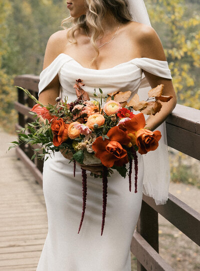 bride and groom walk away during their couples portraits at their fernie wedding