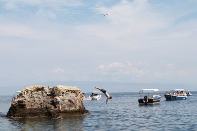 Image of person diving into ocean from Romantic engagement photographer at ADP Studio