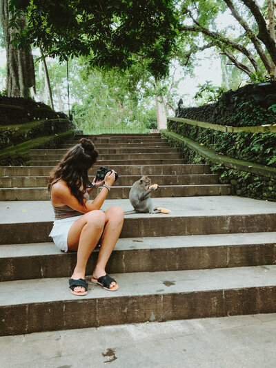 woman taking picture of monkey