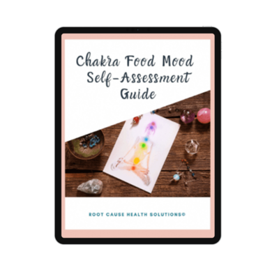 Cover of the “Chakra Food Mood Self-Assessment Guide” displayed on a tablet, featuring chakra art and healing crystals on a wooden table.