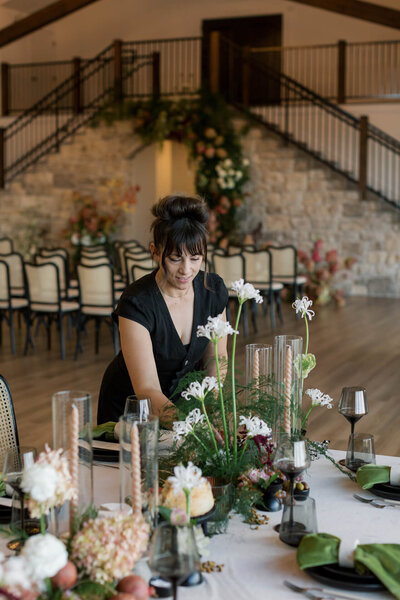 Meridian, Idaho florist, Samantha Green, arranges flowers on a table, representing her vendor profile for the Crush Collective wedding show.