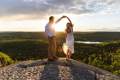 couple walking through trees taken by Minnesota wedding photographer Marcus Hanenburg Photography