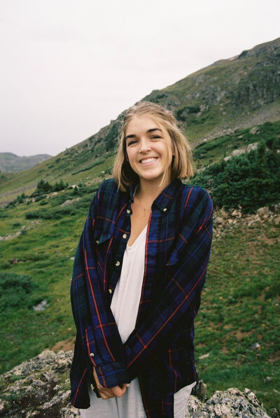 Film photo of wedding photographer standing in the mountains
