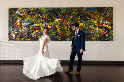 Bride spins in front of painting at The Mae District in Chicago, IL.