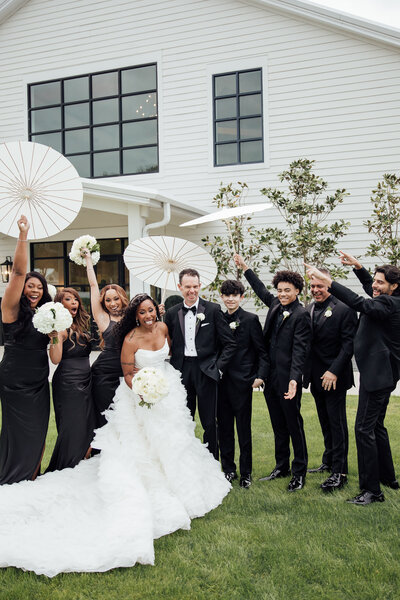 Bride and groom stand in front of classic card