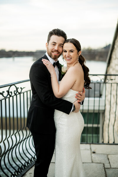 bride in strapless dress poses with groom in black suit