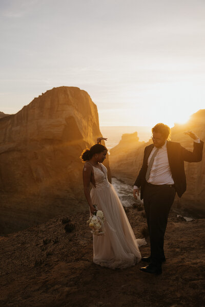 Couple goofing cliff side during their oregon Elopement