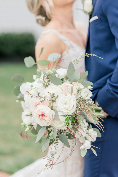 Delicate bridal bouquet of pink roses, dahlias, and eucalyptus leaves, designed by Leigh Florist for a garden wedding