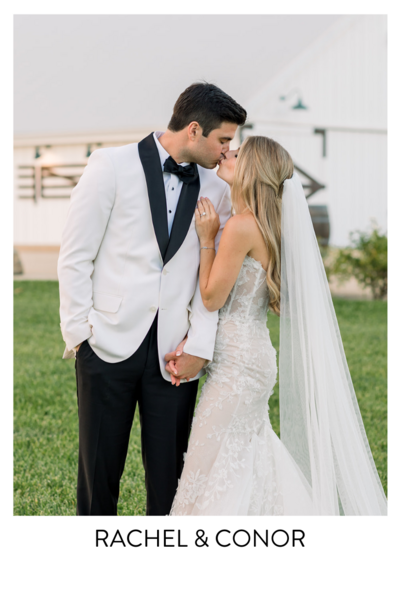 Photo of Bride and Groom kissing in front of the White Barn in San Luis Obispo. Groom is wearing a white tux. 