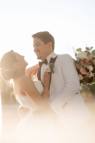 Bride & groom laugh together for a cute photo.