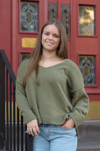 Senior Photos of a girl in downtown Harrisburg, in front of a colorful door.