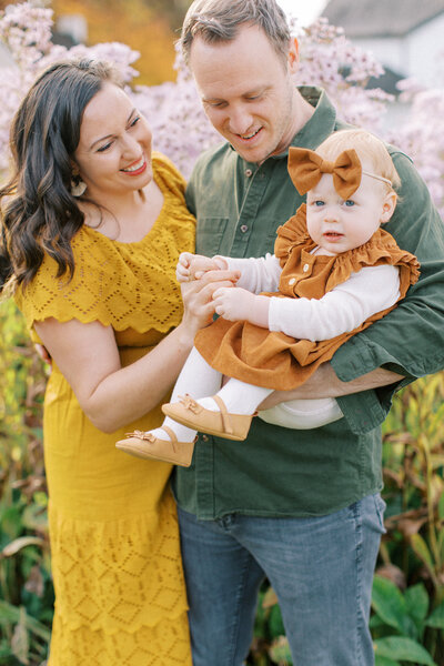 Colorful autumn family with parents and baby girl