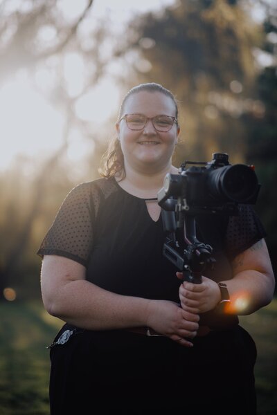 mara shields standing outside in front of a tree at Succop Nature park during a wedding