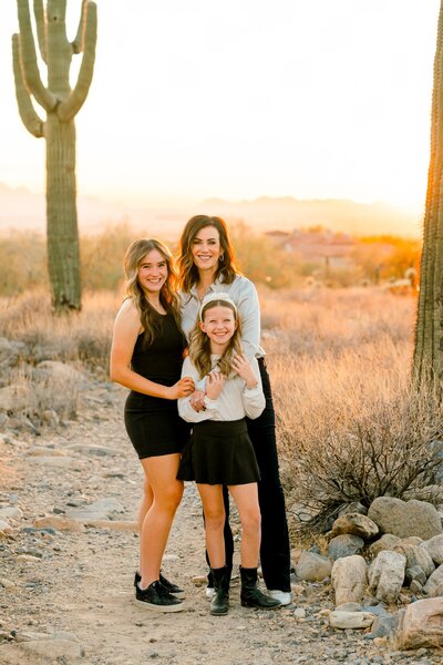 mother and two daughters in the desert smiling at camera 