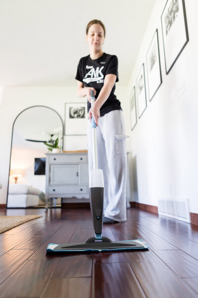 Professional cleaner mopping floor