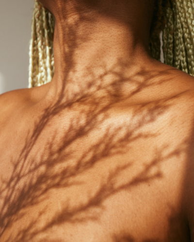 Woman's neck with tree plant shadows