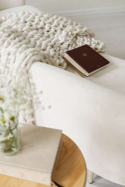 A soft, peaceful scene with a journal on a cozy blanket representing Christ-centered premarital counseling offered by For the Sheepish in Brentwood, Tennessee