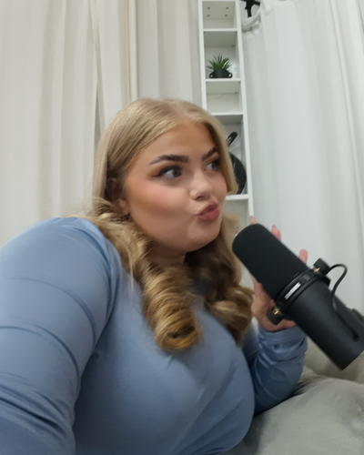 Smiling picture of a social media manager on her phone