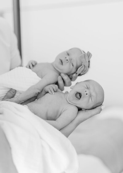 Woman holding baby with man looking down over her shoulder