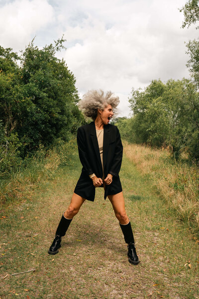 Older woman modeling in field