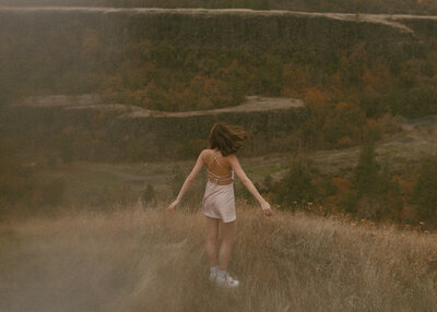girl standing on hillside in columbia river gorge