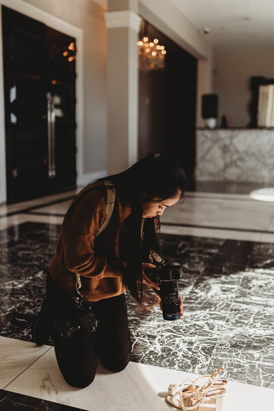 Chara, photographer, reaches her hand out while on the dancefloor of a wedding