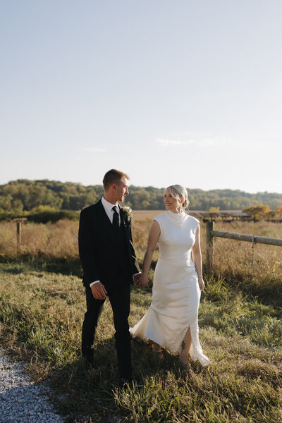 Bride standing on a bridge having wedding portraits done