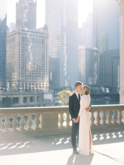 Bride and groom kissing in city photographed by Chicago editorial wedding photographer Arielle Peters
