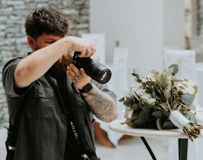Tom Bowen photographing flowers at a wedding