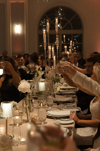 Wedding guests toasting at an elegant reception at The Ritz-Carlton Sarasota, Florida—luxury wedding celebration designed by Watters & Co. Events.
