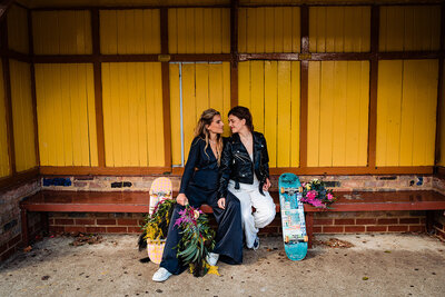 Bride wearing a bridal pink hat hugging and laughing at her gir