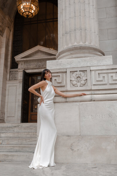black and white image bride wearing feathered wedding dress