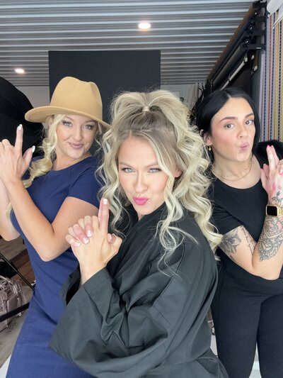 Leslie Q and her leading makeup and hair artist strike a fun Charlie’s Angels pose, showcasing their commitment to taking care of clients. As South Bend’s top luxury portrait team, they ensure a pampering, celebrity-style experience from start to finish.