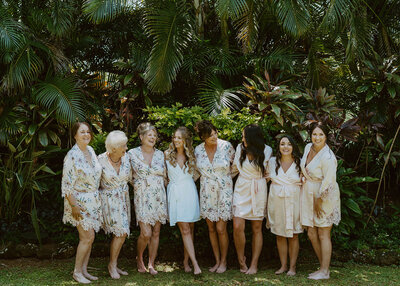 bride and bridesmaids holding eachother