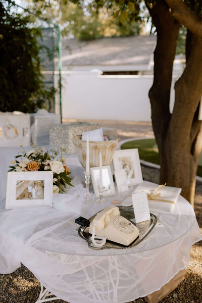 Outdoor tablescape with white flowers and taper candles