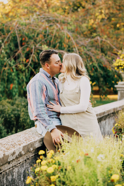 Couple leaning against bridge at Centennial Park