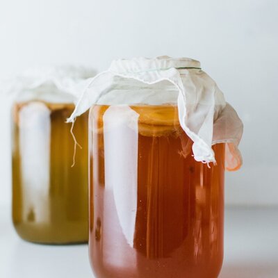 a jar of kombucha and a white cloth