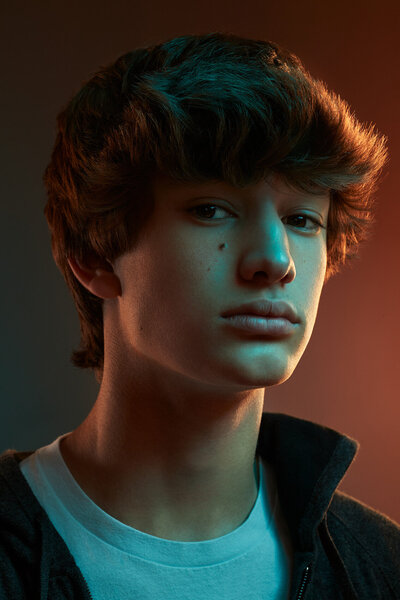 Moody portrait of Henry Cornell with dramatic lighting, captured by Ylva Erevall in a Spotify-themed photoshoot.