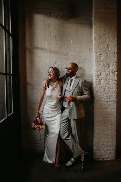 Bride and groom pose for wedding photos at 100 Barrington in London. 