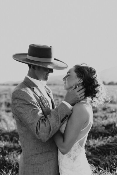 A black and white of the bride and groom  at sunset