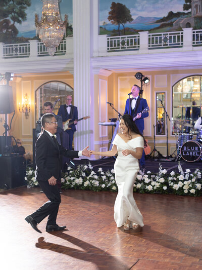 A bride and her father dance together at a wedding reception at the Willard Hotel in Washington DC