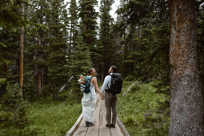 photo of a bride and groom hiking in Colorado taken by adventure elopement photographer